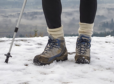 A Woman Hikes In The Snow On The Hills Of Vancouver Island, Duncan, British Columbia, Canada