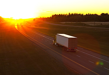 Truck Heading Down A Highway At Sunset, Edmonton, Alberta, Canada