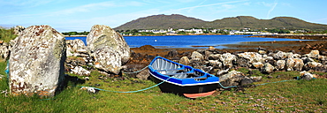 A Boat Tethered On Shore And A View Of Roundstone From Inishnee Island, County Galway, Ireland