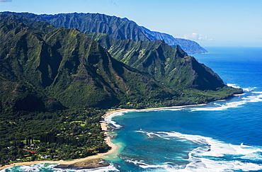 Rugged Mountains Along The Coastline And The Surf Meets The Beach, Haena, Hawaii, United States Of America