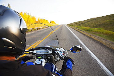 Motorcyclist Riding On The Highway, Near Edmonton, Alberta, Canada