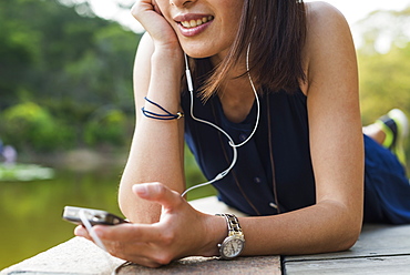 Portrait Of A Young Chinese Woman Listening To Music, Xiamen, Fujian Province, China