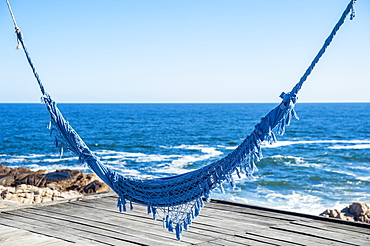 Blue Hammock Over A Wooden Dock At The Water's Edge, Cabo Polonio, Uruguay