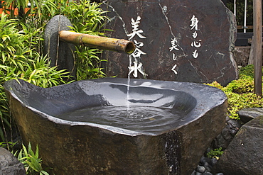 Grey Stone Water Fountain At A Japanese Temple, Kyoto, Japan