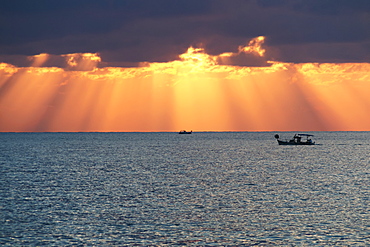 Dramatic Sky With Sun Rays Filtering Down Out Of The Storm Clouds Over The Horizon, Paphos, Cyprus