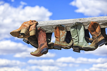 Old Cowboy Boots Hanging In Memory Of John Booth, Great Sandhills, Near Sceptre, Saskatchewan, Canada