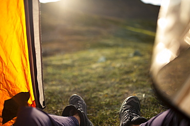 Pov View Of Hikers Feet And The View Of Tundra From The Doorway Of A Tent, Alaska