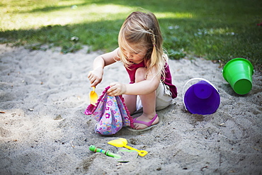 A Young Girl Plays In The Sand, Surrey, British Columbia, Canada