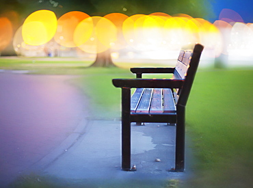 Bench Along A Path With Glowing Yellow Lights In The Distance, Penticton, British Columbia, Canada