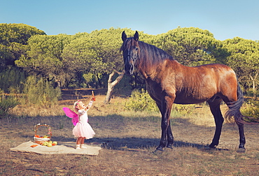 Young Girl With Pink Ferry Wings And A Brown Horse, Tarifa, Cadiz, Andalusia, Spain