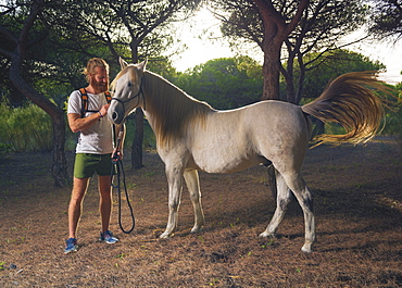 A Man Standing With A White Horse, Cadiz, Andalusia, Spain