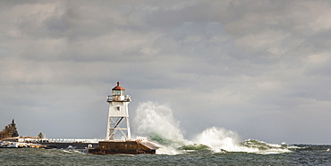 Large Waves Splashing Up To A Lighthouse, Grand Marais, Minnesota, United States Of America