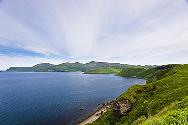 Aerial View Of Rocky Cliffs And Green Bluffs Along The Shore Of Popof Island Near Sand Point, Southwestern Alaska, USA, Summer