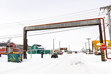 A Barrow Resident On An Atv Stops At A Above Ground Utilities Bridge, Barrow, North Slope, Arctic Alaska, USA, Winter