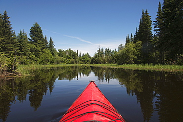 Red Bow Of A Boat On A Tranquil Lake, Ontario, Canada