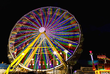 Colourful Lights Of A Moving Ferris Wheel At Nighttime, Calgary, Alberta, Canada