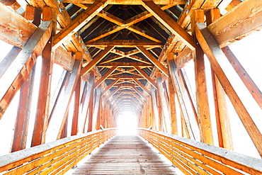 Wooden Bridge With Sunlight Glowing At The End, Golden, British Columbia, Canada