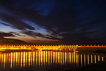 Dam Over The Euphrates River Lit Up At Nighttime, Turkey