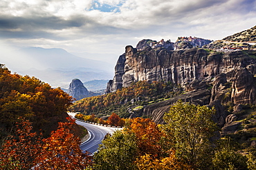 Monasteries Perched On Cliffs And A Winding Road In Autumn Foliage, Meteora, Greece