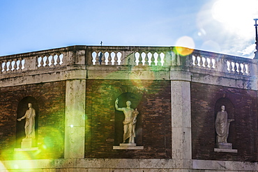 Statues In Niches On A Brick Wall With Balustrades Along The Top With Sunlight Streaming Down, Piazza Del Quirinale, Rome, Italy