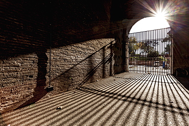 Bars At Entrance Closed And Shadow Cast On The Ground, Rome, Italy