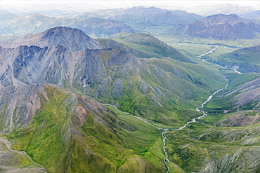 Aerial View Of A River Cutting Through A Valley In The Brooks Range, Alaska, United States Of America