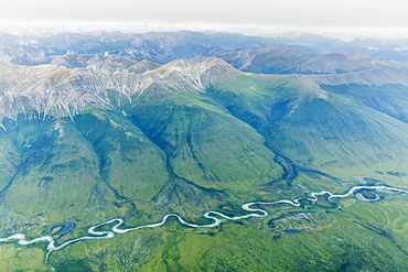 Aerial View Of A River Cutting Through A Valley In The Brooks Range, Alaska, United States Of America