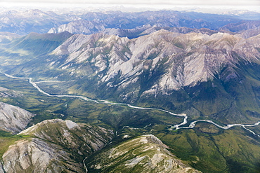 Aerial View Of A River Cutting Through A Valley In The Brooks Range, Alaska, United States Of America