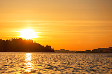 The Setting Sun Silhouettes The Forest Ridges And Peninsulas In Prince William Sound, Whittier, Alaska, United States Of America