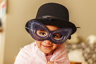 Young Girl Playing Dress Up Wearing A Mask And Hat, Edmonton, Alberta, Canada