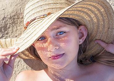 A Girl Laying On The Sand Wearing A Sunhat, Tarifa, Cadiz, Andalusia, Spain