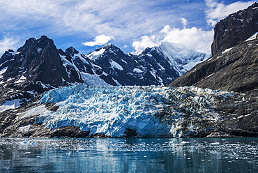 Blue Glacier Between Snow-Capped Mountains And Fjord, Antarctica