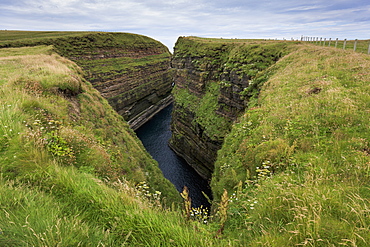 Water In A Gorge Between Grass Covered Cliffs, Caithness, Scotland