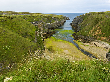 A Waterway Between The Cliffs Of The Coast Leading Into A River In The Highlands, Scotland