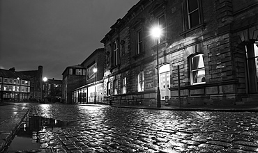 Light From A Lamp Post Illuminating Wet Cobblestone Road, South Shields, Tyne And Wear, England