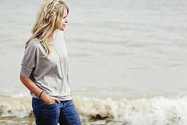 Portrait Of A Young Woman With Long Blond Hair At The Ocean, Hastings, Sussex, England