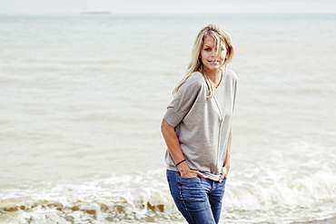 Portrait Of A Young Woman With Long, Blond Hair At The Atlantic Ocean, Hastings, Sussex, England