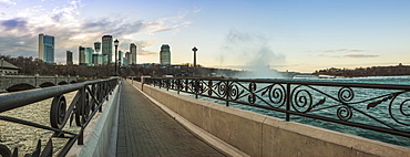 A Walkway With A City Skyline In The Background, Niagara Falls, Ontario, Canada