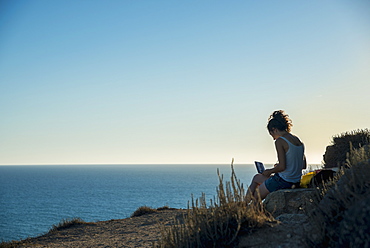 Girl Painting At The Water's Edge, Tharros, Sardinia, Italy