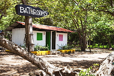 Sign For The Bathrooms Outside A Small Structure With Two Doorways At Playa Hermosa, Near San Juan Del Sur, Nicaragua