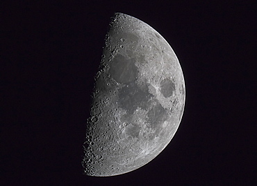 Half Of The Moon Illuminated In A Dark Sky