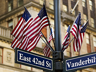 American Flags On A Pole Above The Street Signs At The Intersection Of East 42nd Street And Vanderbilt, New York City, New York, United States Of America