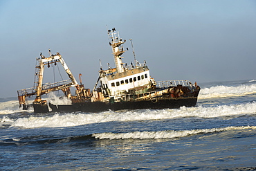 A Rusty Sunken Abandoned Ship In The Waves Of Atlantic Ocean On The Namibian Coast (Zeila Shipwreck), Namibia