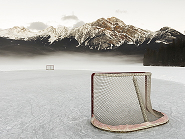 A Hockey Net On Frozen Pyramid Lake With The Rugged Canadian Rockies Mountain Range In The Background, Jasper National Park, Alberta, Canada