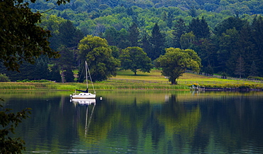 Sailboat At Dusk On A Lake With The Mirror Image Reflected In The Water, Knowlton, Quebec, Canada