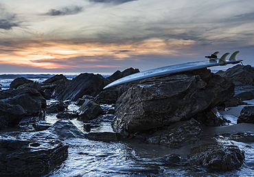 Surf Board On The Rocks Along The Coast, Tarifa, Cadiz, Andalusia, Spain