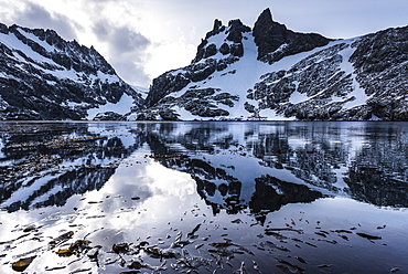 Reflections Of Snow Covered Rugged Mountains In Water, Antarctica