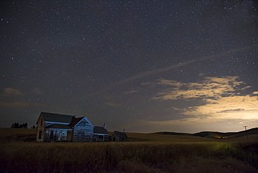 Stars Glowing In The Sky At Dusk Over A Farmhouse, Palouse, Washington, United States Of America