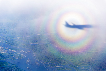 Aerial View Of The Shadow Of A Commercial Airline In The Middle Of A Sundog Over A Cloudy North Slope Tundra, North Slope, Alaska, United States Of America