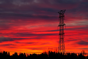 Silhouette Of A Tall Metal Electrical Tower With Colourful Dramatic Sky At Sunrise, Calgary, Alberta, Canada